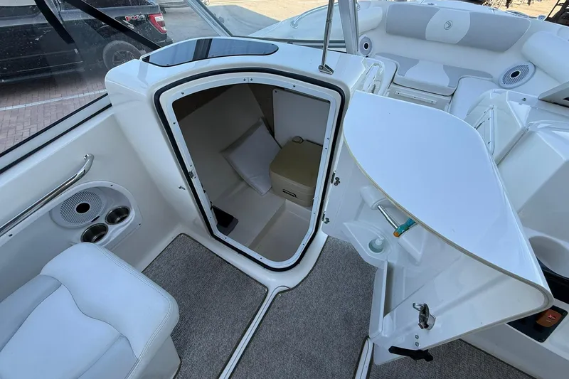 Slide: The Image of 2011 Edgewater 205CX Crossover boat interior with open cabin door and seating area. - 30