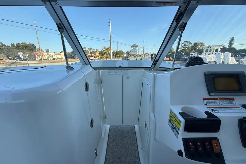 Slide: The Image of 2011 Edgewater 205CX Crossover boat interior with dashboard and controls. - 36