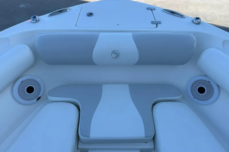Slide: The Image of 2011 Edgewater 205CX Crossover boat interior with cushioned seating and built-in speakers. - 40