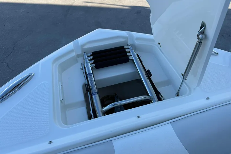 Slide: The Image of Open storage compartment on 2011 Edgewater 205CX Crossover boat with ladder. - 41