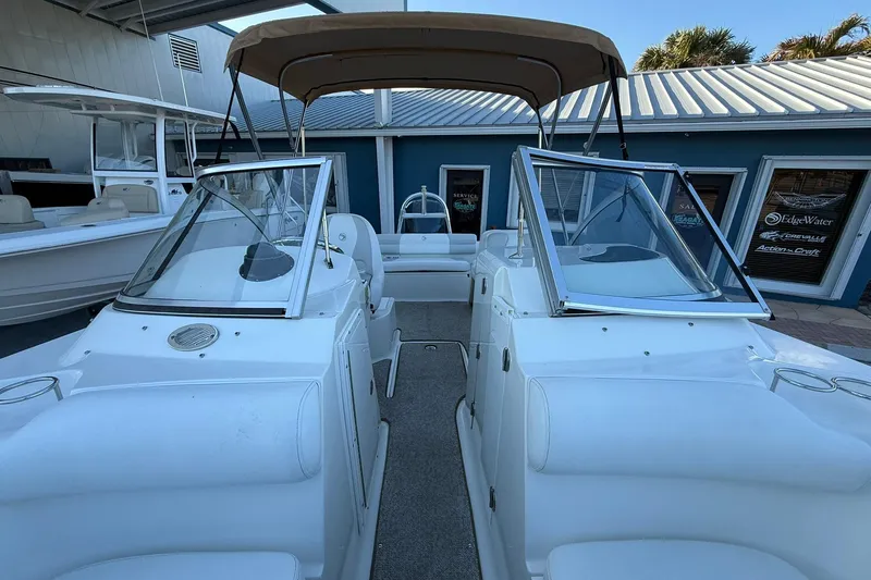 Slide: The Image of 2011 Edgewater 205CX Crossover boat with open windshield and canopy, docked at marina. - 42