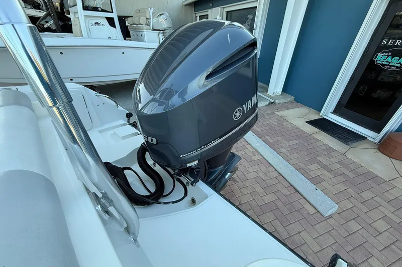 Slide: The Image of 2011 Edgewater 205CX Crossover with Yamaha outboard motor, docked near service area. - 8