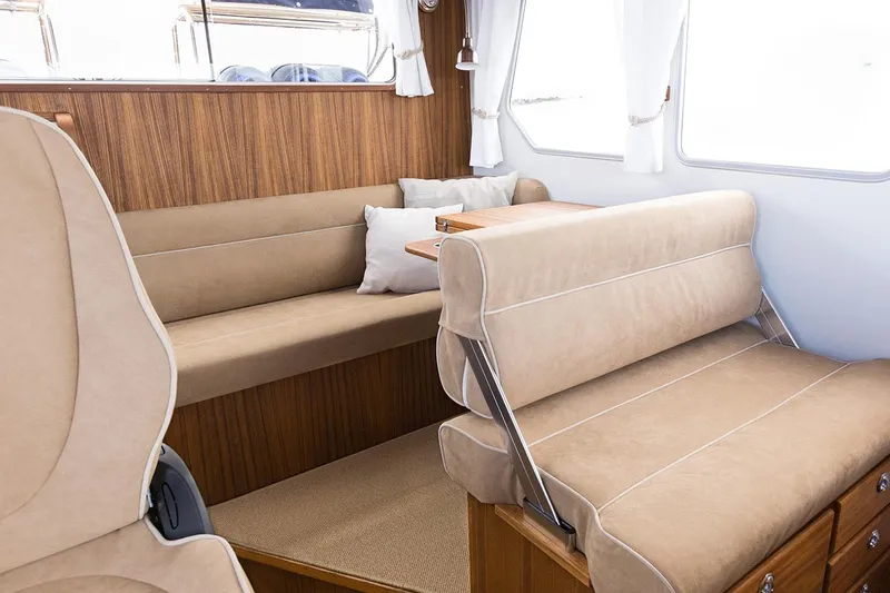 Slide: The Image of Interior of Targa 30.1 yacht, 2027 model, featuring beige upholstery. - 13