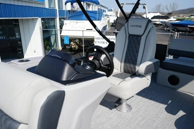Slide: The Image of 2026 Harris Cruiser 230 SLDH boat interior with steering wheel and captain's chair. - 15
