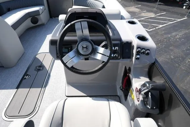 Slide: The Image of 2026 Harris Cruiser 230 SLDH boat interior with steering wheel and control panel. - 16