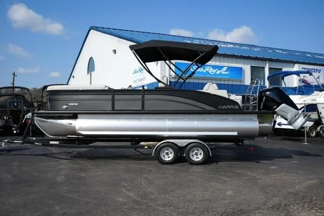 The Image of 2026 Harris Cruiser 230 SLDH pontoon boat on trailer, parked outside a dealership. - 5