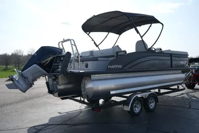 Slide: The Image of 2026 Harris Cruiser 230 SLDH pontoon boat on trailer, featuring sleek design and canopy. - 9