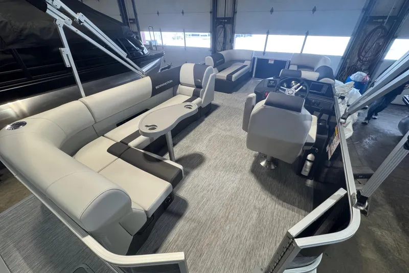 Slide: The Image of 2026 Bennington 20 S-One L-Bench pontoon boat interior with modern seating and helm. - 12