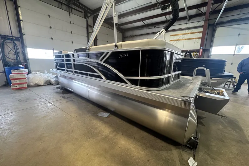 Slide: The Image of 2026 Bennington 20 S-One L-Bench pontoon boat in a warehouse setting. - 14