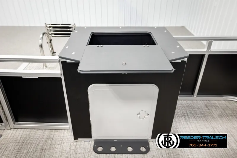 Slide: The Image of 2026 Avalon VEN RF boat interior with storage compartment and ladder, Reeder Trausch Marine branding. - 23