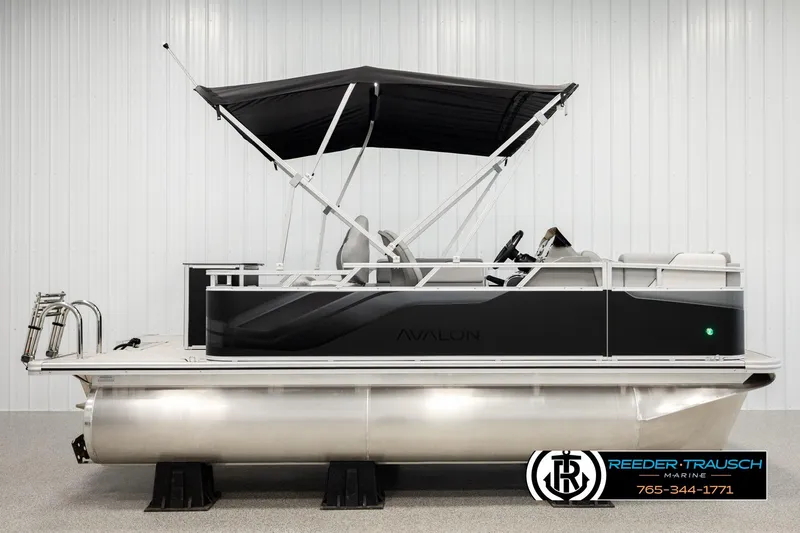 Slide: The Image of 2026 Avalon VEN RF pontoon boat with black canopy in showroom. - 5