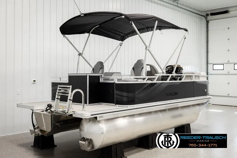 Slide: The Image of 2026 Avalon VEN RF pontoon boat in showroom with canopy and modern design. - 6