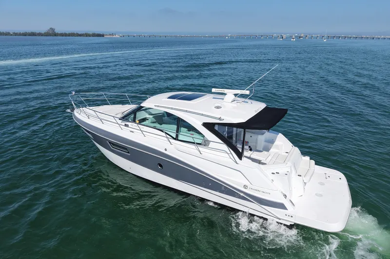 The Image of 2018 Cruisers Yachts 41 Cantius cruising on open water under clear skies. - 0