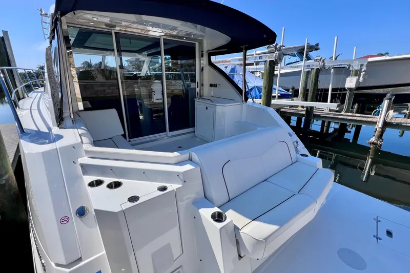 Slide: The Image of 2018 Cruisers Yachts 41 Cantius docked, featuring spacious seating and sleek design. - 13