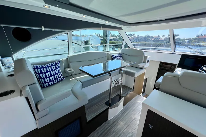 Slide: The Image of Luxurious interior of 2018 Cruisers Yachts 41 Cantius with modern seating and glass table. - 28