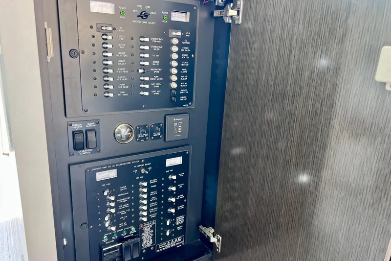 Slide: The Image of Electrical control panel on 2018 Cruisers Yachts 41 Cantius, showcasing switches and gauges. - 32