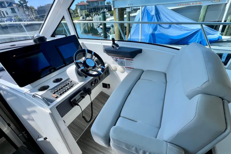 Slide: The Image of 2018 Cruisers Yachts 41 Cantius helm with dual screens and plush seating. - 35