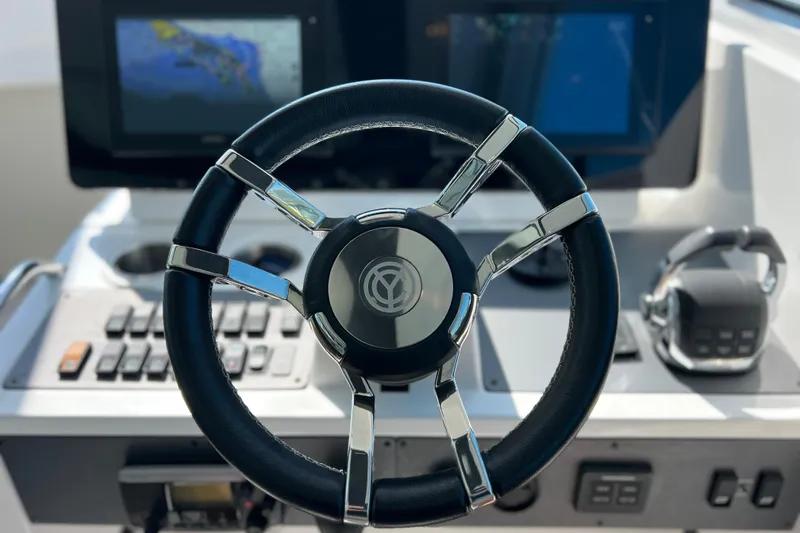 Slide: The Image of Steering wheel of 2018 Cruisers Yachts 41 Cantius with navigation screens in background. - 38