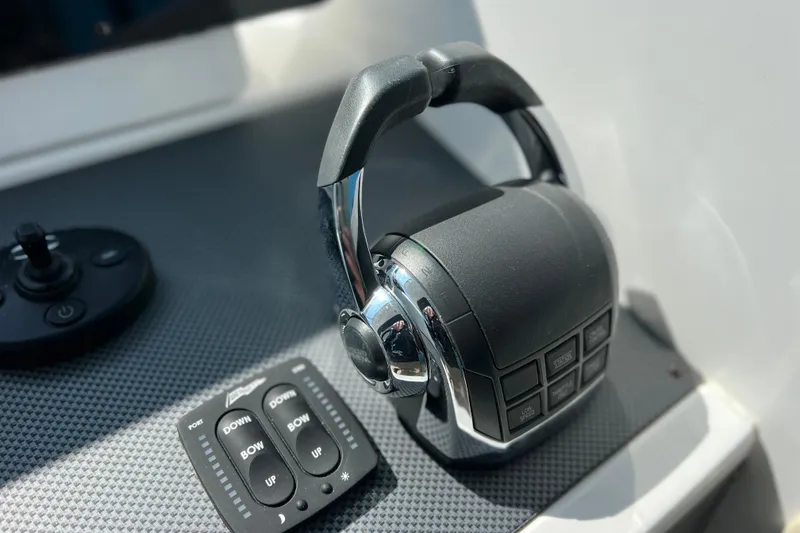 Slide: The Image of Throttle controls on 2018 Cruisers Yachts 41 Cantius dashboard, featuring joystick and trim buttons. - 40