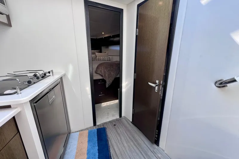 Slide: The Image of 2018 Cruisers Yachts 41 Cantius interior with kitchenette and bedroom view. - 60