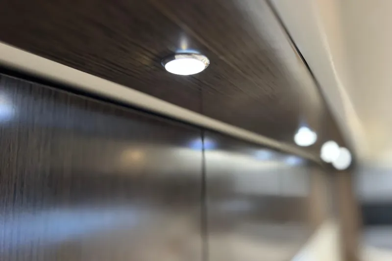 Slide: The Image of LED lighting on 2018 Cruisers Yachts 41 Cantius interior, highlighting sleek wood finish. - 64