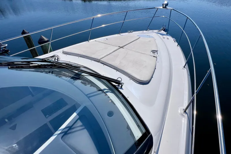 Slide: The Image of 2018 Cruisers Yachts 41 Cantius bow view with sunpad and railing on calm water. - 76