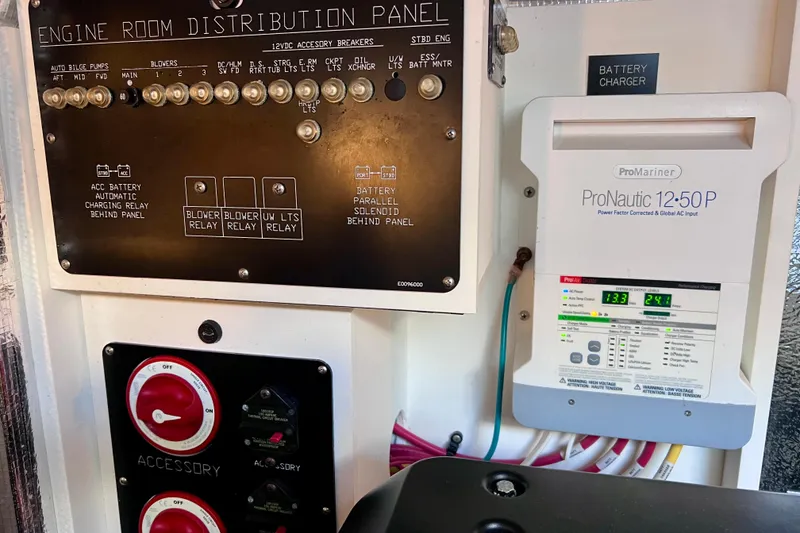 Slide: The Image of Engine room distribution panel and battery charger on 2018 Cruisers Yachts 41 Cantius. - 93