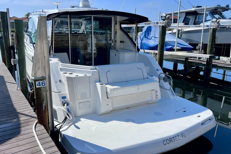 Slide: The Image of 2018 Cruisers Yachts 41 Cantius docked, rear view, in Cortez, Florida marina. - 12