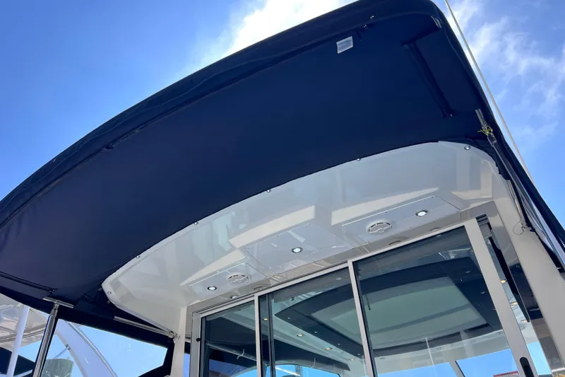 Slide: The Image of 2018 Cruisers Yachts 41 Cantius, featuring sleek design and modern amenities under a clear blue sky. - 24