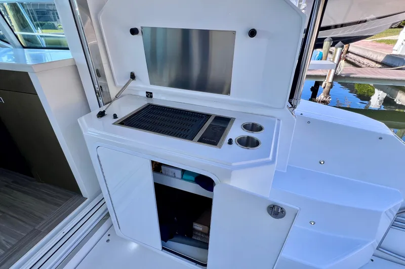Slide: The Image of Outdoor kitchen on 2018 Cruisers Yachts 41 Cantius with grill and storage. - 26