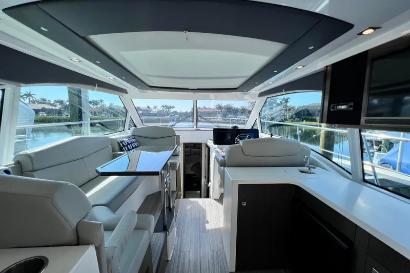 Slide: The Image of Luxurious interior of 2018 Cruisers Yachts 41 Cantius with modern seating and panoramic windows. - 27