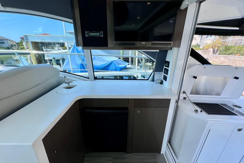 Slide: The Image of Interior of 2018 Cruisers Yachts 41 Cantius with kitchenette and window view. - 29