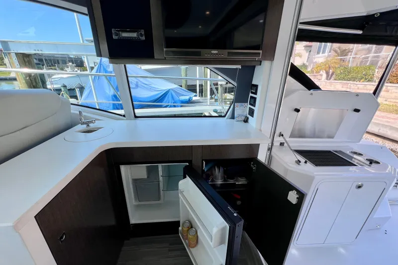Slide: The Image of 2018 Cruisers Yachts 41 Cantius interior kitchen with sink, fridge, and grill. - 30