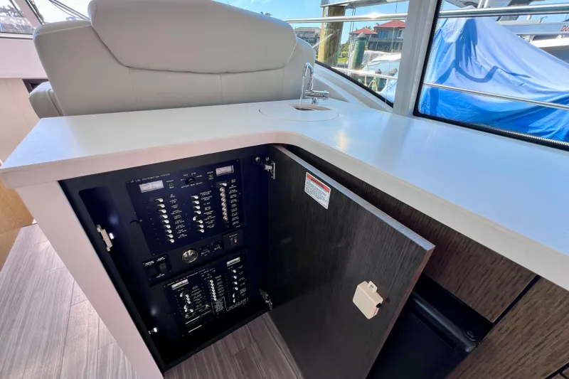 Slide: The Image of 2018 Cruisers Yachts 41 Cantius electrical panel and sink area. - 31