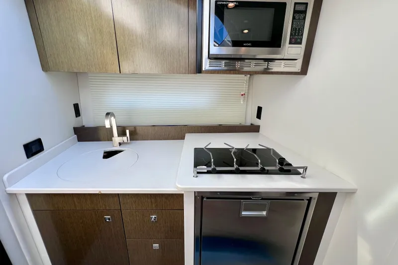 Slide: The Image of 2018 Cruisers Yachts 41 Cantius kitchen with stove, sink, and microwave. - 50
