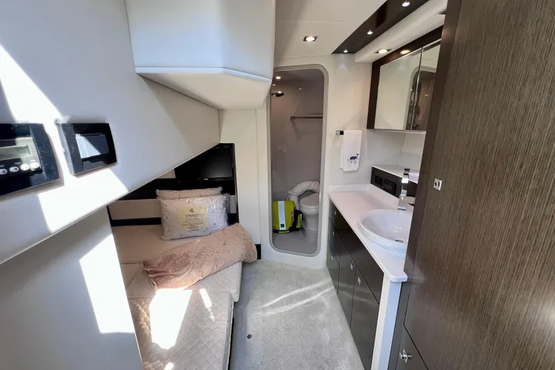 Slide: The Image of Luxurious interior of 2018 Cruisers Yachts 41 Cantius with modern bathroom and cozy sleeping area. - 52