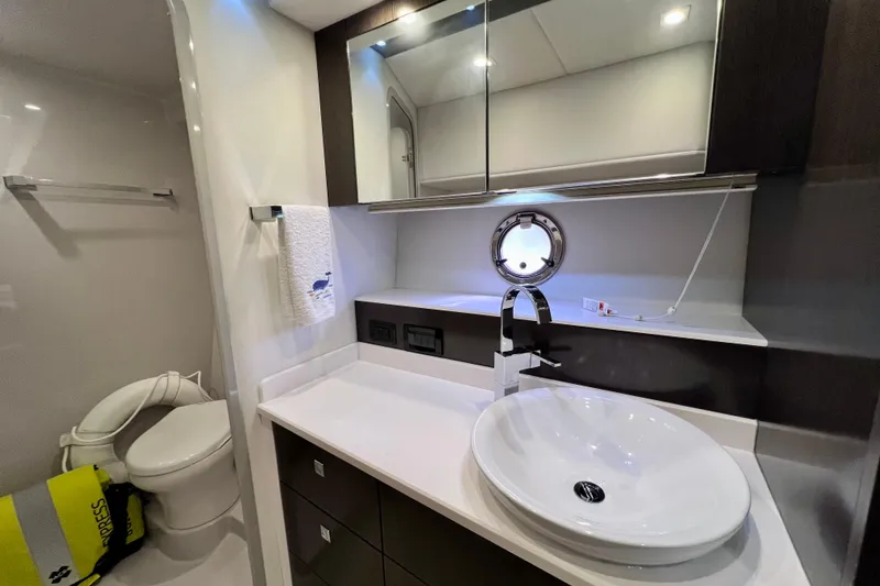 Slide: The Image of Luxurious bathroom in 2018 Cruisers Yachts 41 Cantius, featuring modern sink and porthole window. - 54