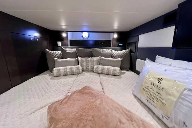 Slide: The Image of Luxurious 2018 Cruisers Yachts 41 Cantius cabin interior with plush bedding and elegant decor. - 55