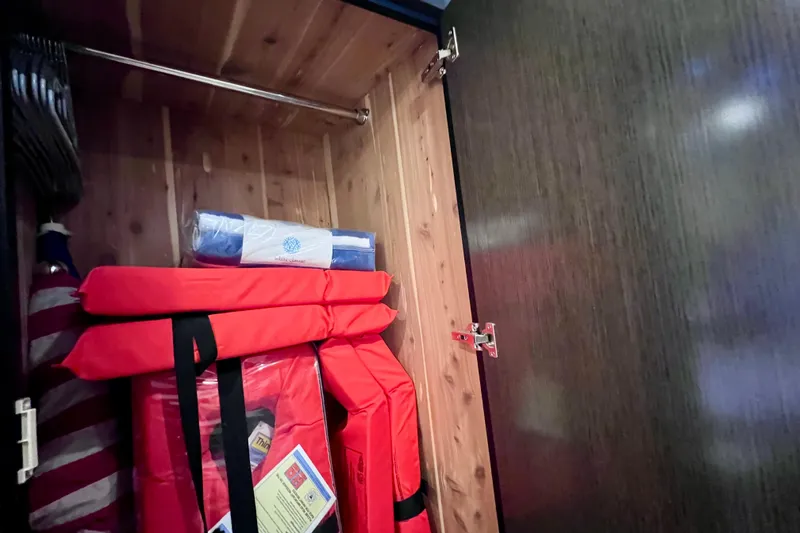 Slide: The Image of Storage cabinet on 2018 Cruisers Yachts 41 Cantius with life jackets and safety equipment. - 57