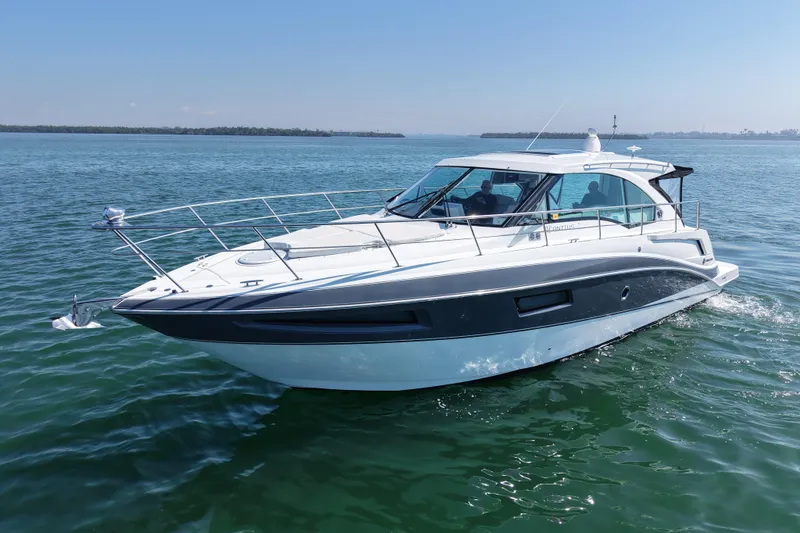 Slide: The Image of 2018 Cruisers Yachts 41 Cantius cruising on calm waters under a clear blue sky. - 6