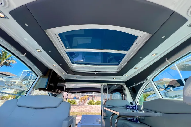 Slide: The Image of Interior of 2018 Cruisers Yachts 41 Cantius with panoramic sunroof and modern seating. - 71