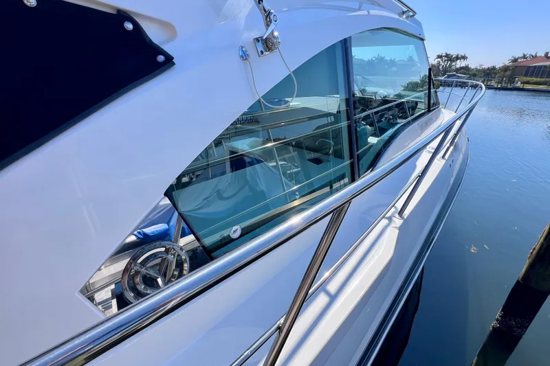 Slide: The Image of 2018 Cruisers Yachts 41 Cantius, sleek design, docked on calm water. - 74