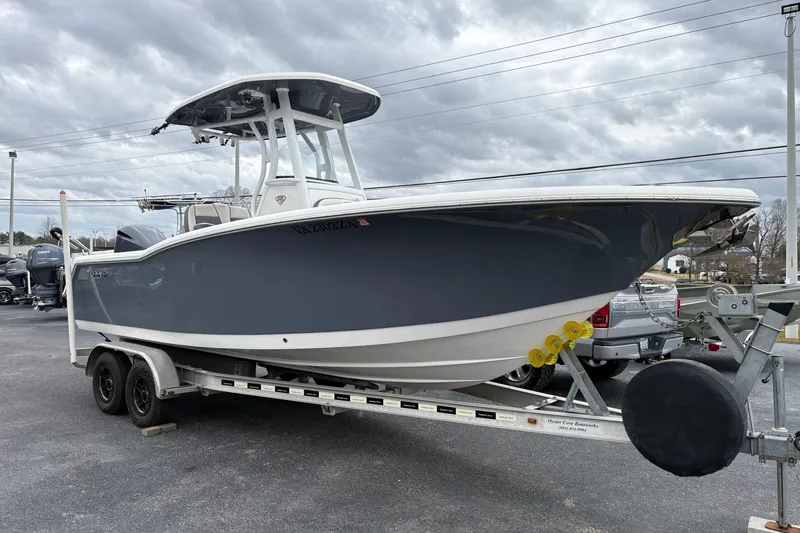 The Image of 2019 Tidewater 232 CC Adventure boat on trailer under cloudy sky. - 0
