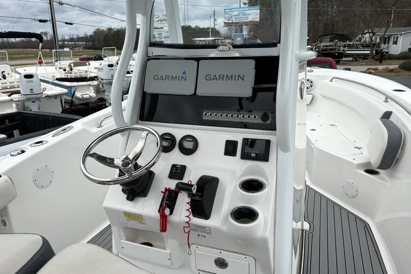 Slide: The Image of 2019 Tidewater 232 CC Adventure boat console with Garmin navigation system and steering wheel. - 11