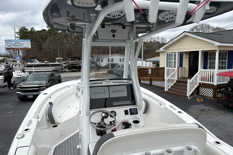 Slide: The Image of 2019 Tidewater 232 CC Adventure boat with Garmin electronics, parked near a building. - 12