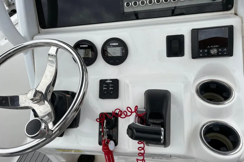 Slide: The Image of 2019 Tidewater 232 CC Adventure boat dashboard with steering wheel, Yamaha gauges, and JL Audio system. - 13