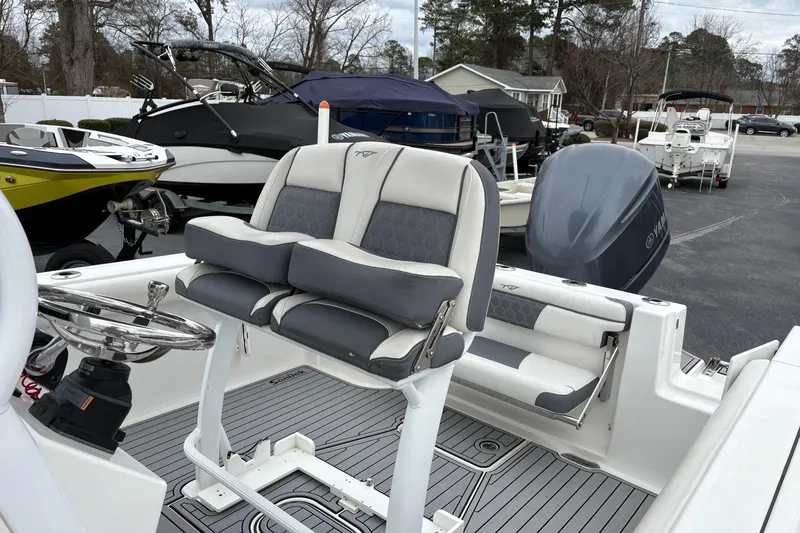 Slide: The Image of 2019 Tidewater 232 CC Adventure boat interior with dual seats and steering wheel. - 18