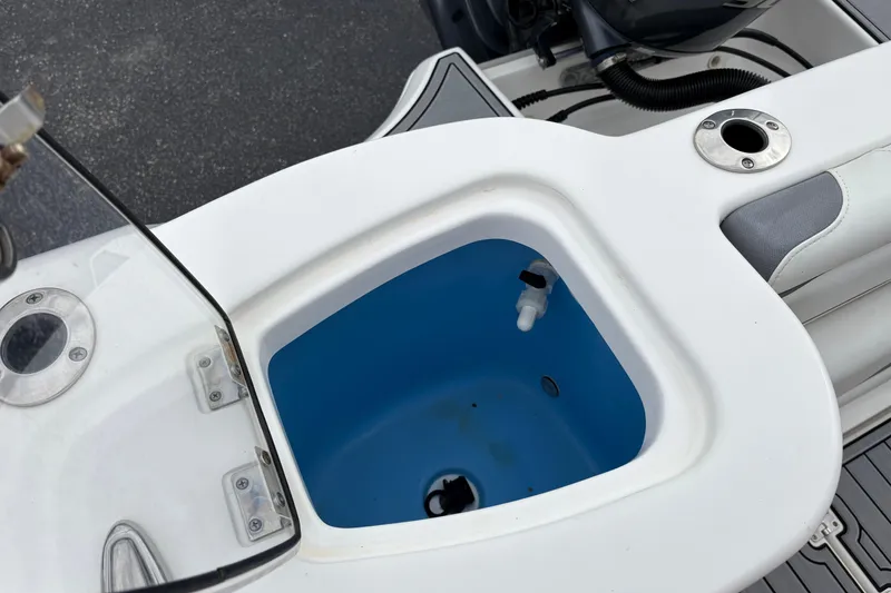 Slide: The Image of Livewell on 2019 Tidewater 232 CC Adventure boat, featuring blue interior and white exterior. - 19