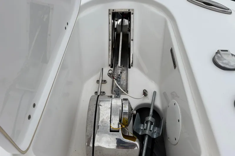 Slide: The Image of 2019 Tidewater 232 CC Adventure boat anchor compartment with winch and anchor. - 26