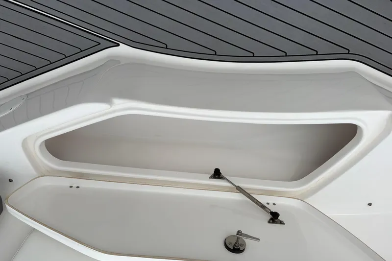Slide: The Image of 2019 Tidewater 232 CC Adventure boat storage compartment with open hatch. - 29